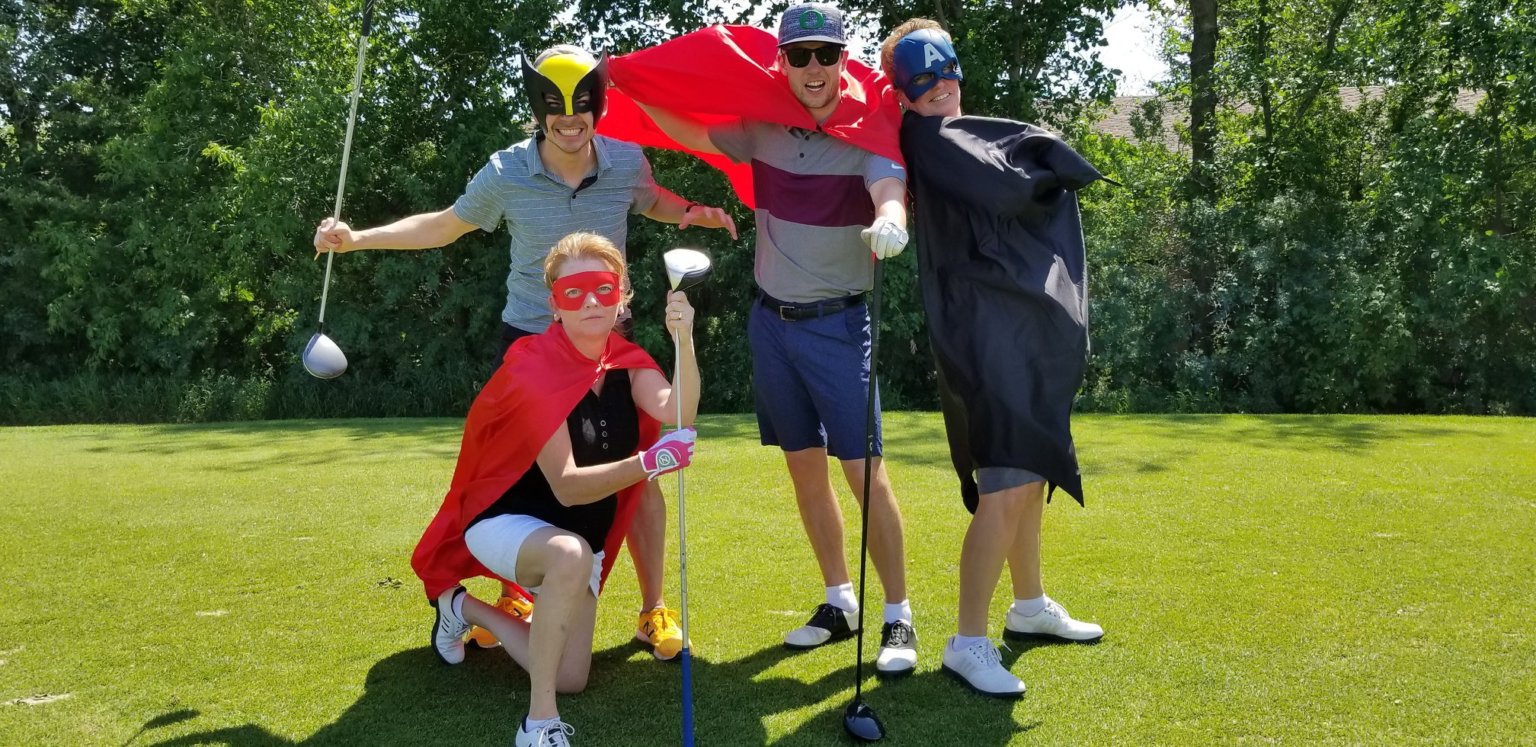 Golfers having fun in superhero costumes